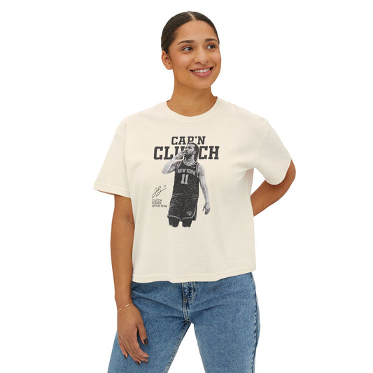 Woman wearing a white t-shirt with text 'Cap'N CLUTCH' on a white background